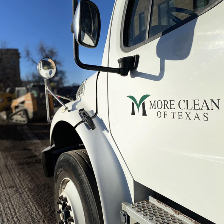Close up of logo on the door of More Clean of Texas sweeper truck providing Milling Sweeping Services in color.