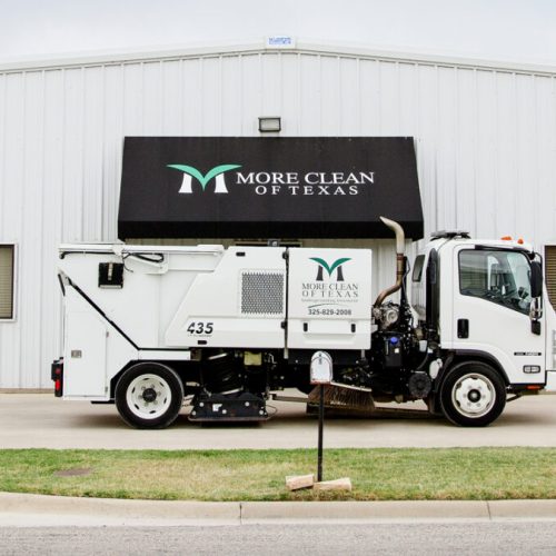 Sweeper Truck parked in front of More Clean of Texas