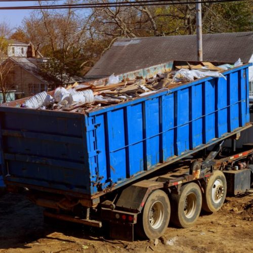 More Clean of Texas Debris Haul Off truck picking up roll off dumpster